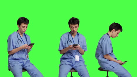 Nurse-browsing-online-websites-on-smartphone-app-in-studio